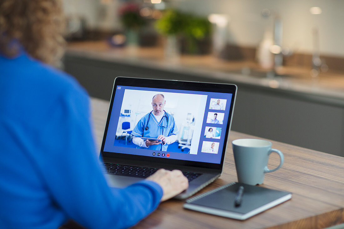 Woman video conferencing with doctor on laptop screen