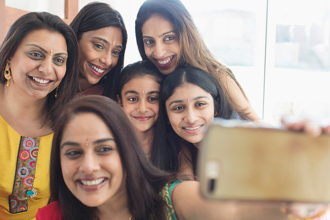 Happy Indian women and girls with binds taking selfie