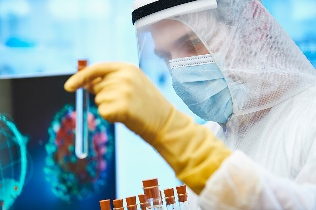 Male scientist with test tube studying coronavirus vaccine