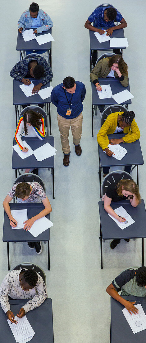 Teacher supervising students taking exam