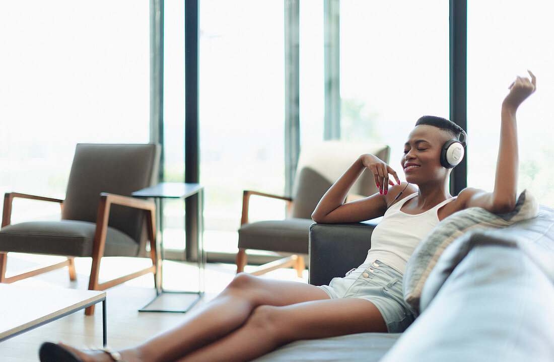 Serene, happy young woman listening to music