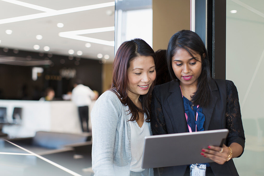 Businesswomen using digital tablet in office