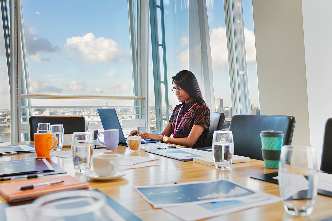 Focused businesswoman working at laptop