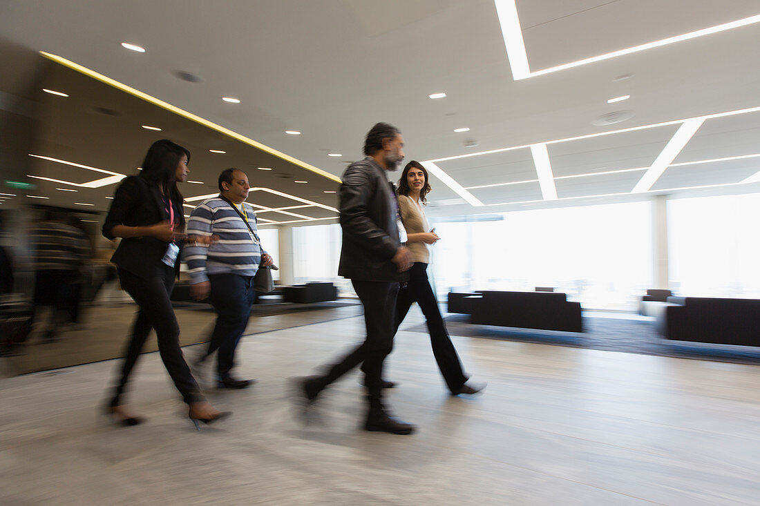 Business people walking in office lobby