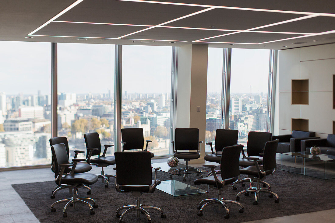 Chairs in circle in modern urban highrise office