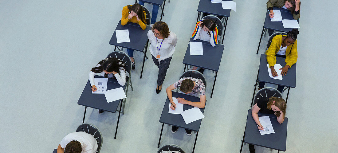 Teacher supervising students taking exam