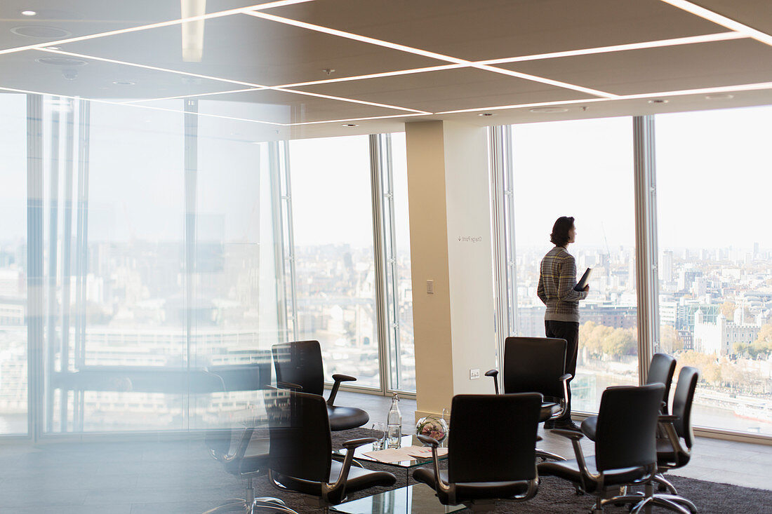 Thoughtful businessman at highrise office window