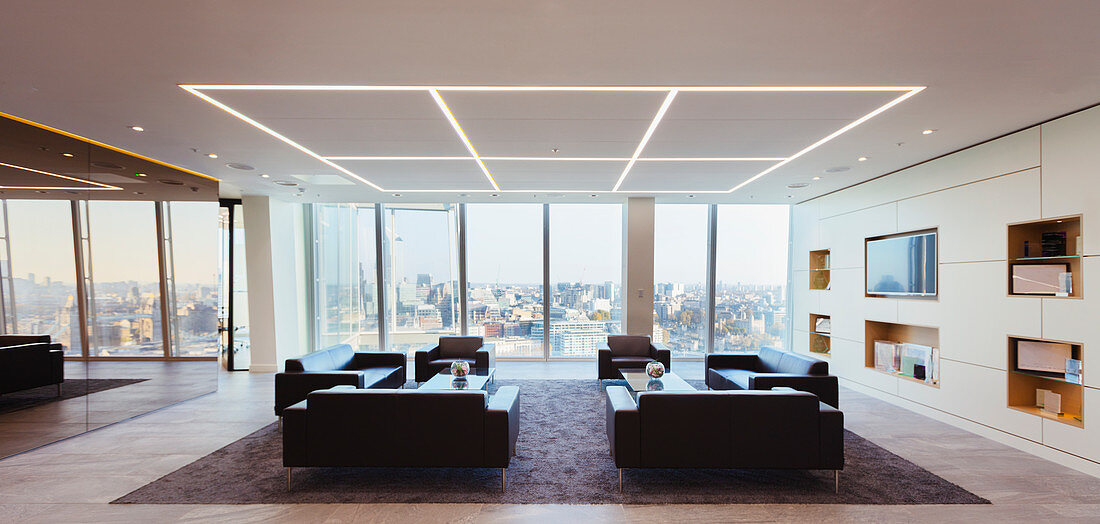 Sofas in modern urban highrise office lounge