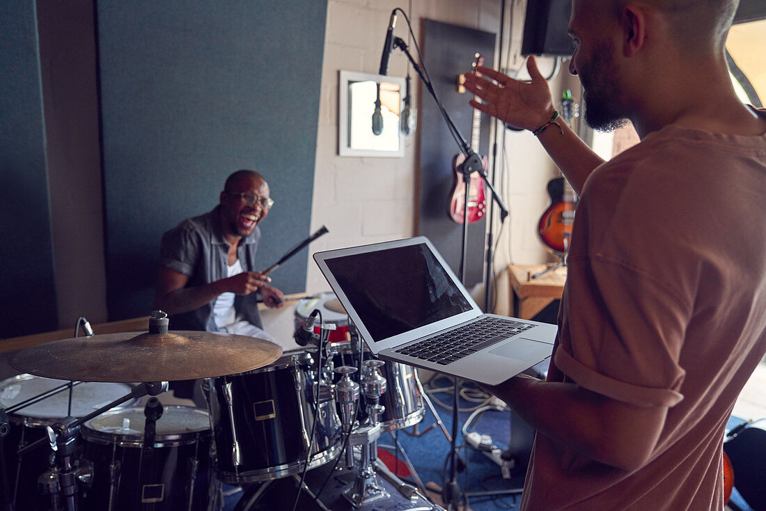 Musicians with drums and laptop