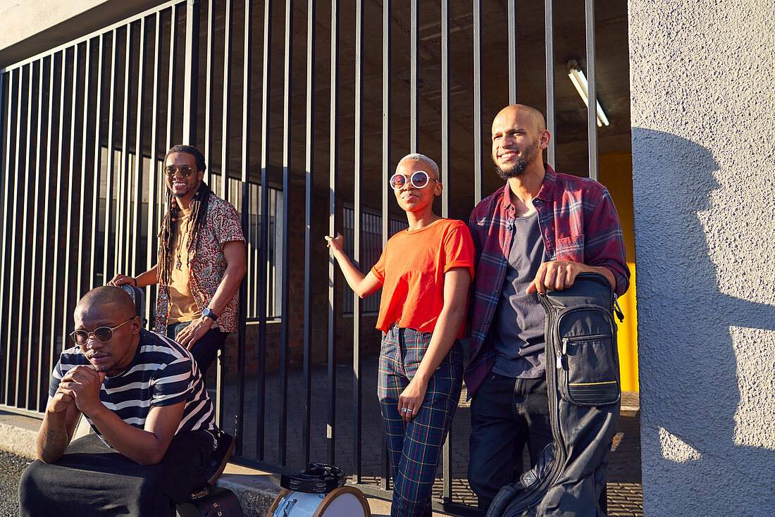 Portrait musicians outside sunny parking garage