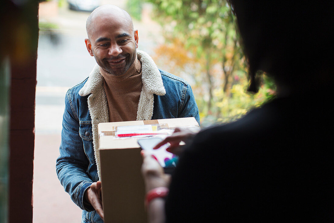 Delivery man delivering package to woman