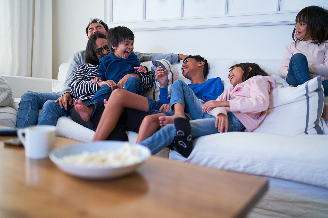 Playful family on living room sofa