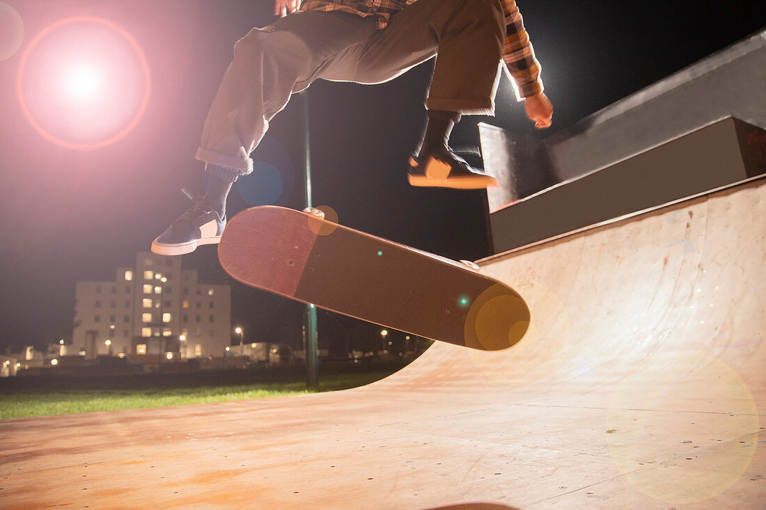 Young man skateboarding on ramp at skate park