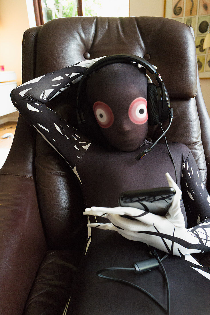 Boy in alien costume wearing headset