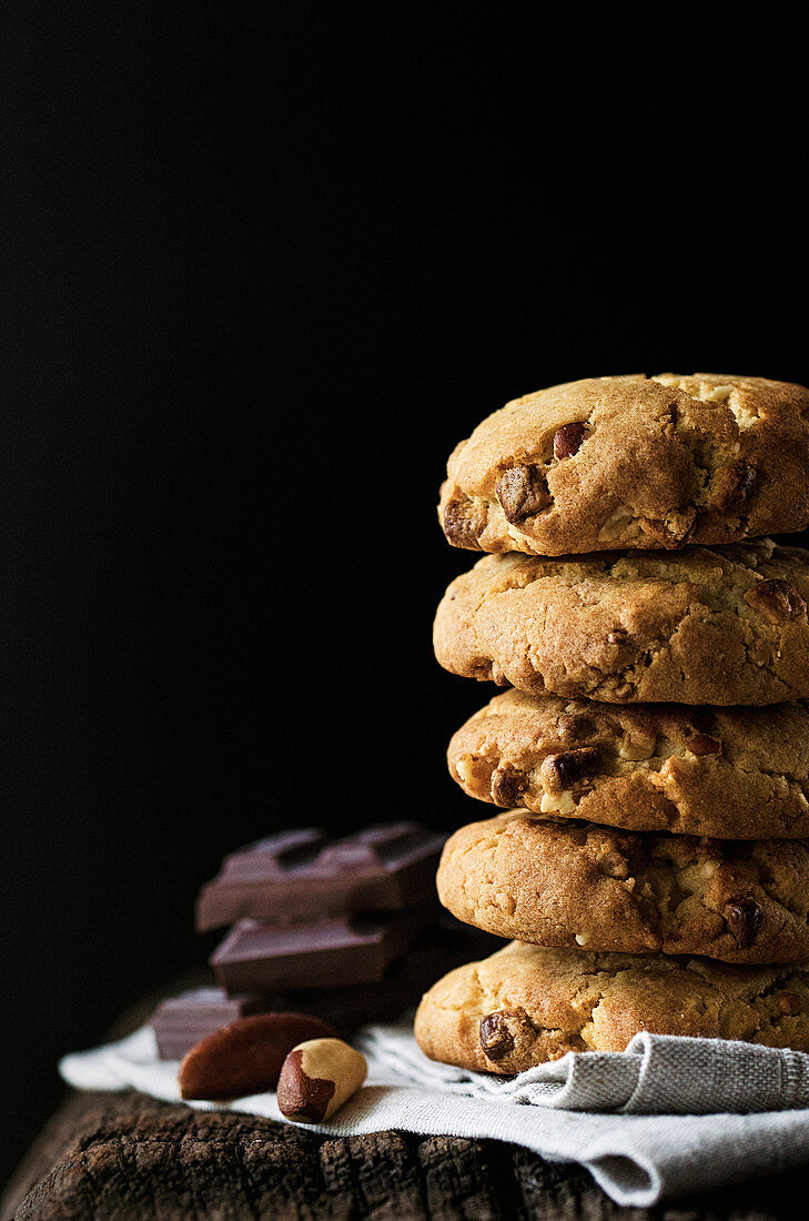 Stack of chocolate chip cookies with Brazil nuts
