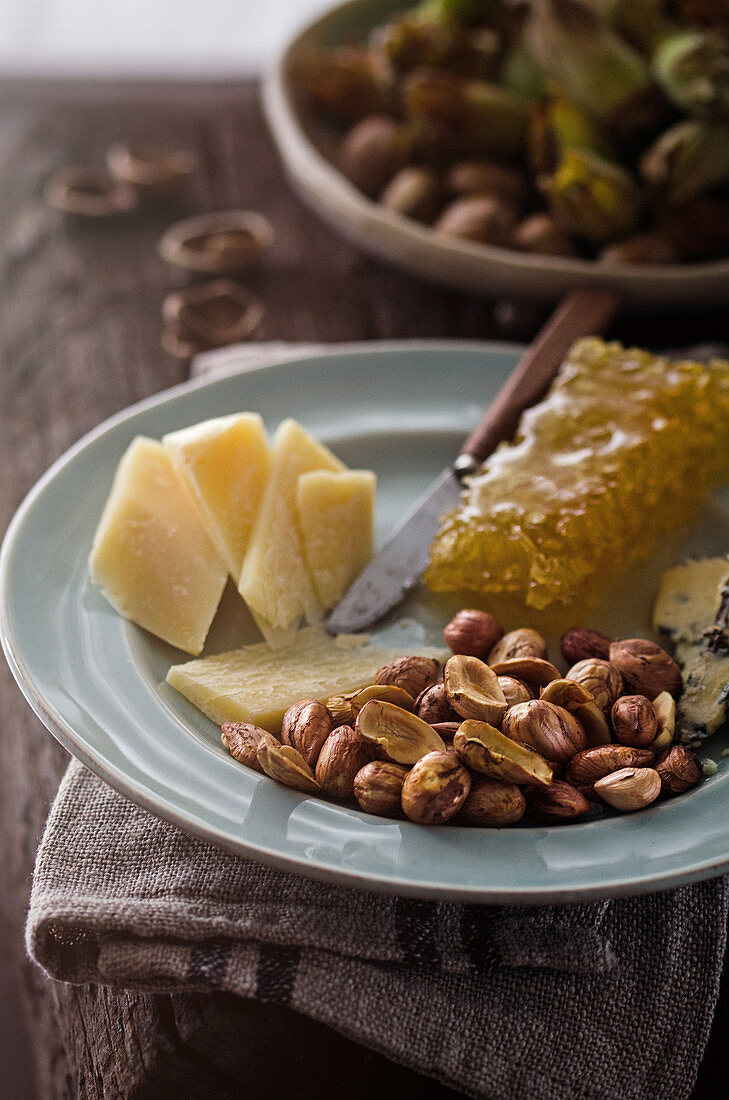 Cheese platter with honeycomb and hazelnuts