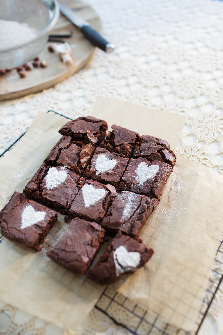 Powdered sugar hearts on brownies on cooling rack