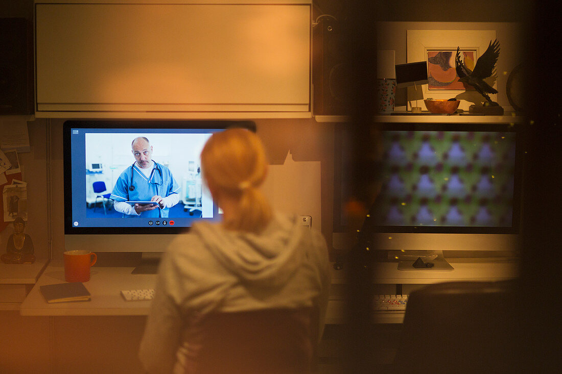 Woman video conferencing with doctor