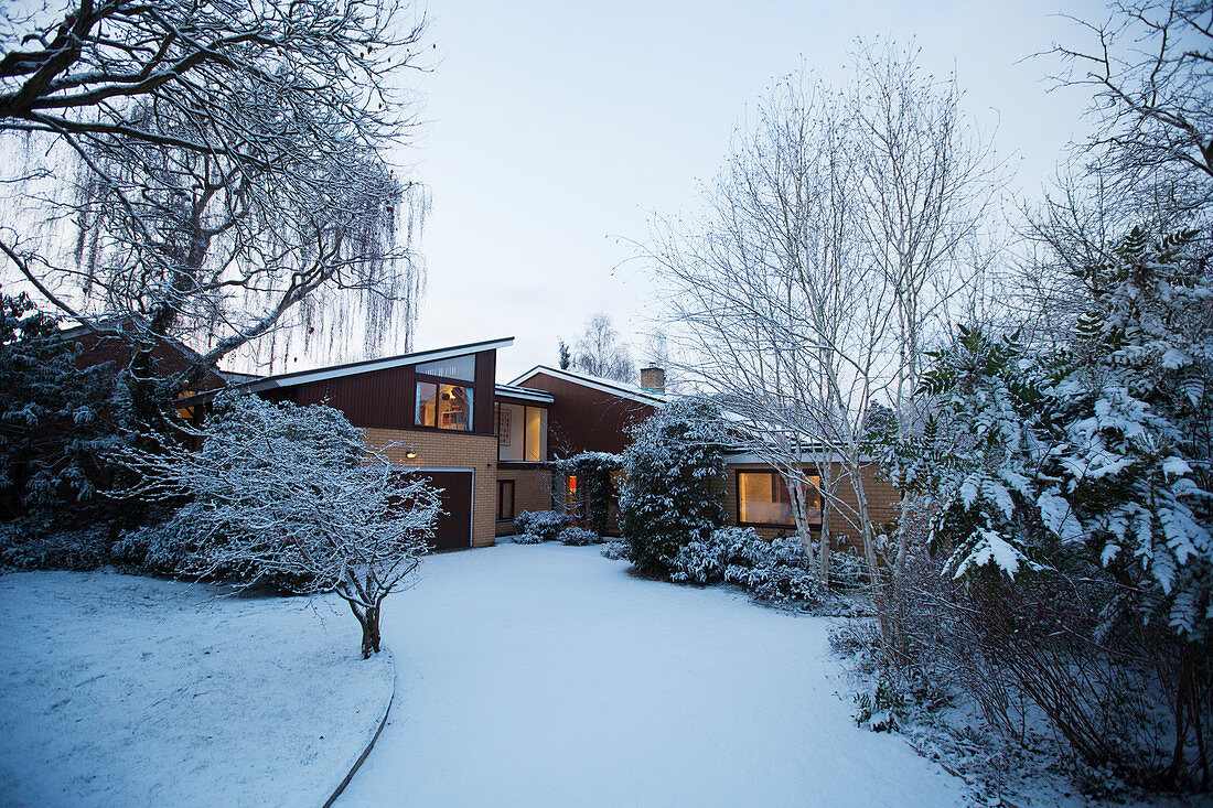 Snowy home showcase exterior and driveway