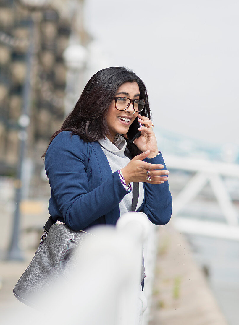 Businesswoman talking on smart phone outdoors