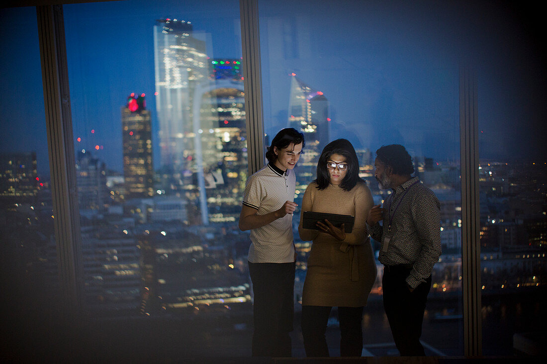 Business people with tablet at highrise window