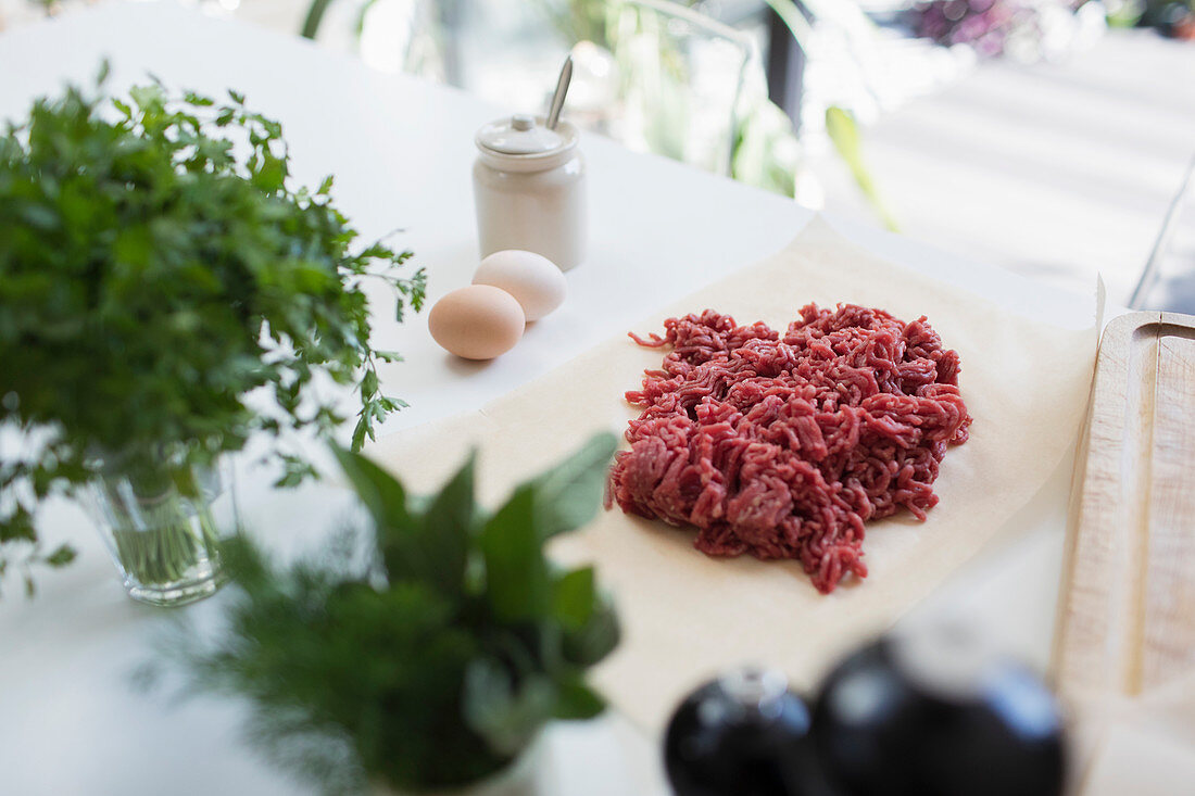 Raw ground beef and herbs