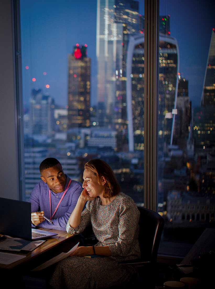 Business people at laptop, London, UK
