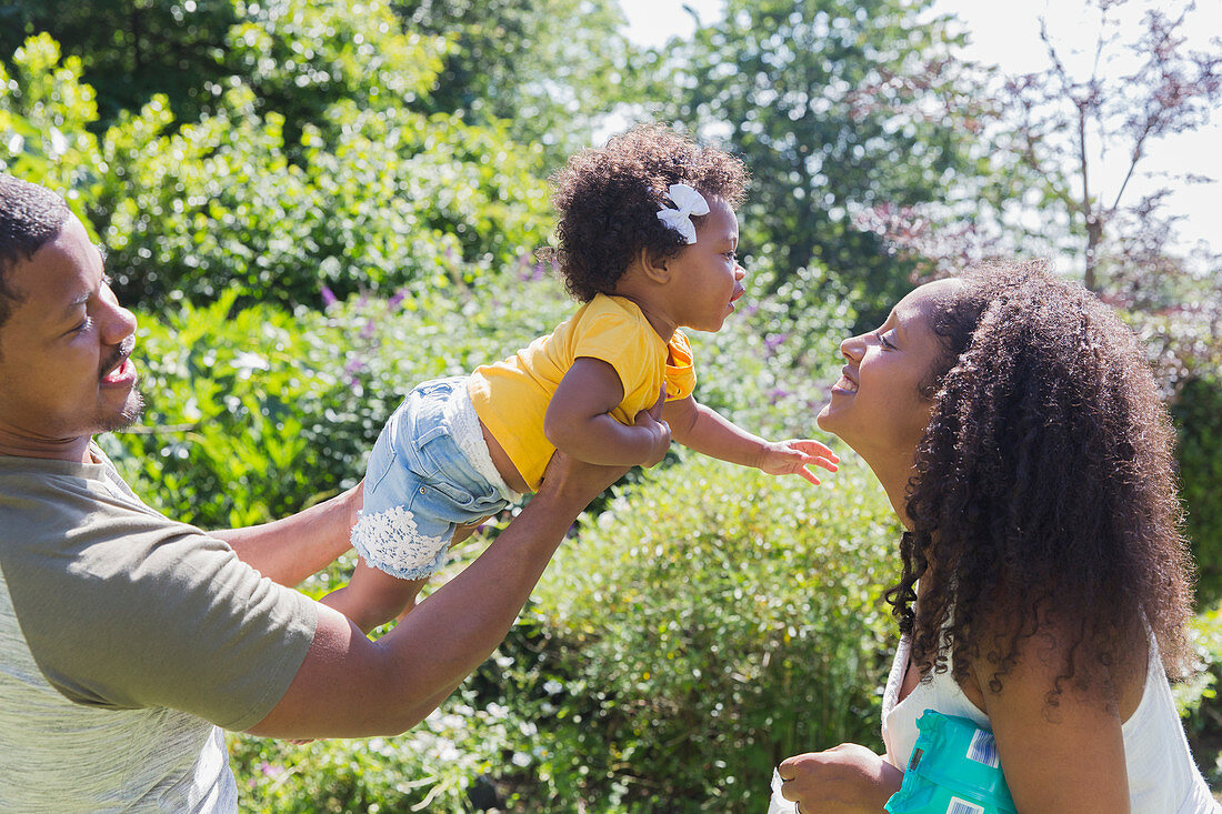 Affectionate parents and toddler daughter