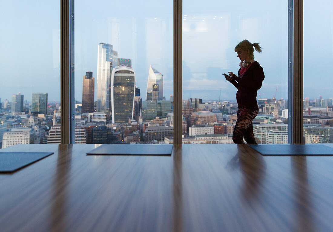 Businesswoman using smart phone, London, UK