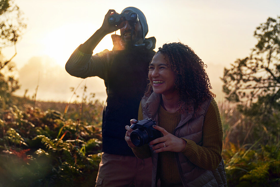 Happy hiking couple with binoculars