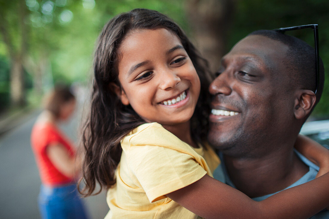 Close up happy father and daughter hugging