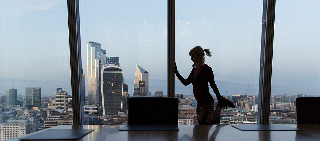 Businesswoman stretching, London, UK