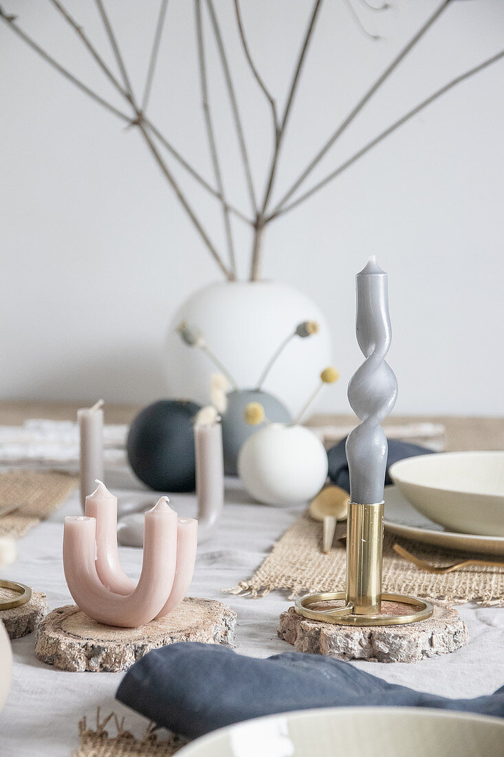 Arrangement of artistically twisted and curved candles on table