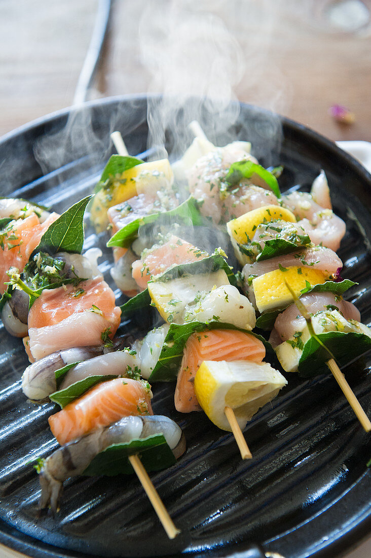 Steaming fish skewers in a grill pan