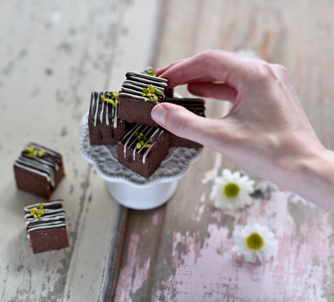 Vegan chai, chocolate and millet bites decorated with chocolate and pistachio nuts