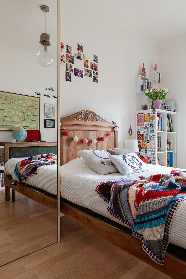 Floor-to-ceiling mirror and wooden bed in girl's bedroom room