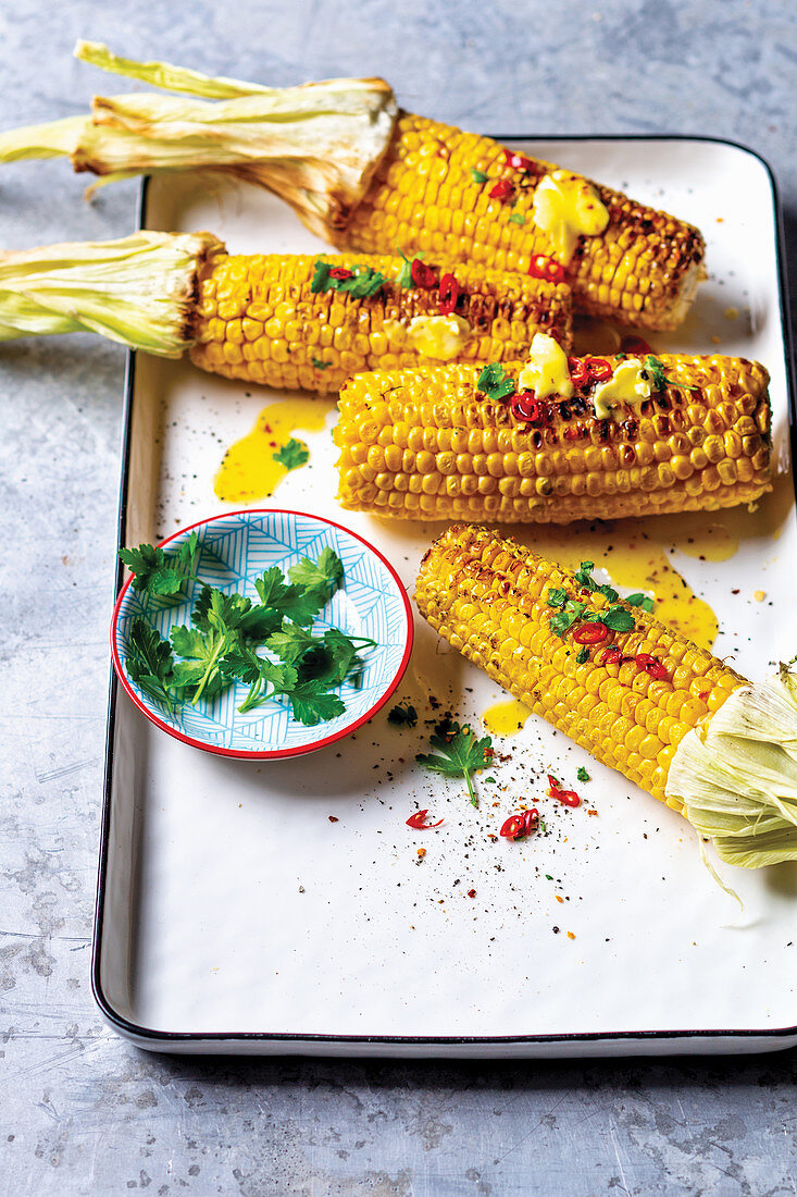 Grilled corn cobs with spice butter, coriander and chilli