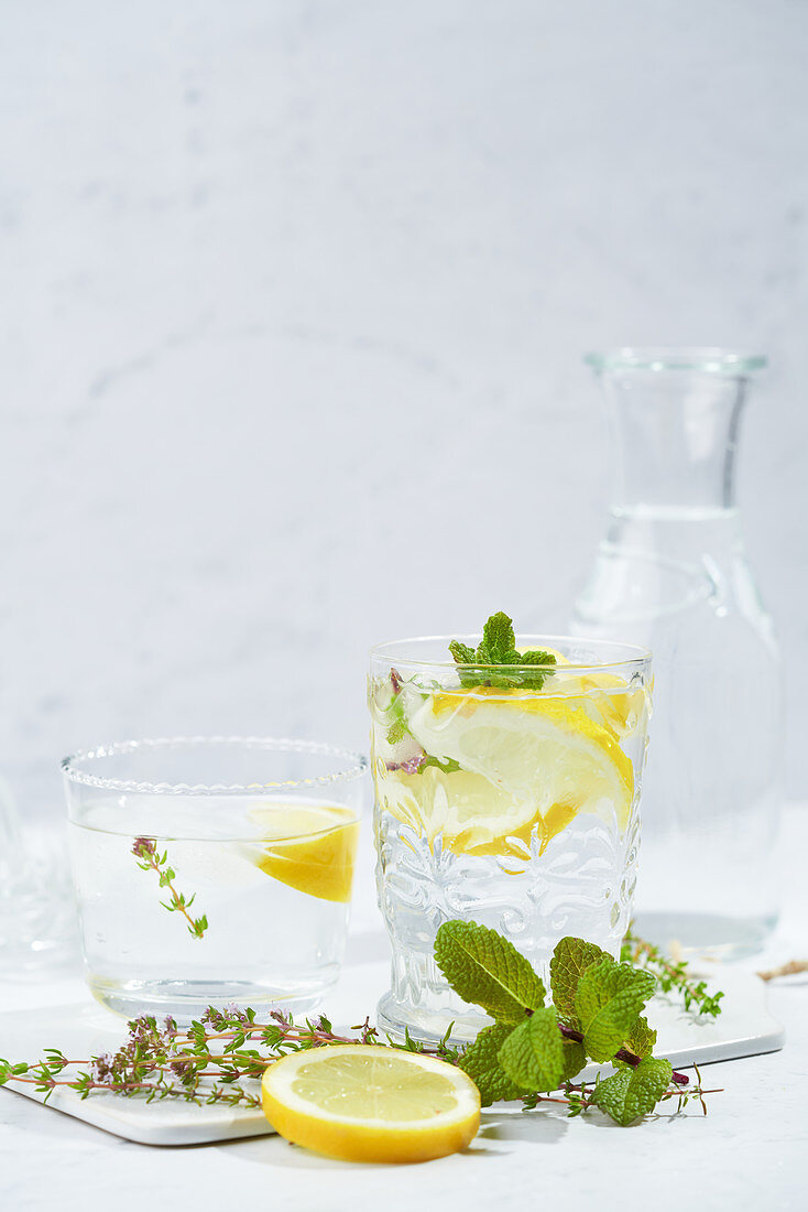 Glasses with refreshing cold thyme and ginger lemonade