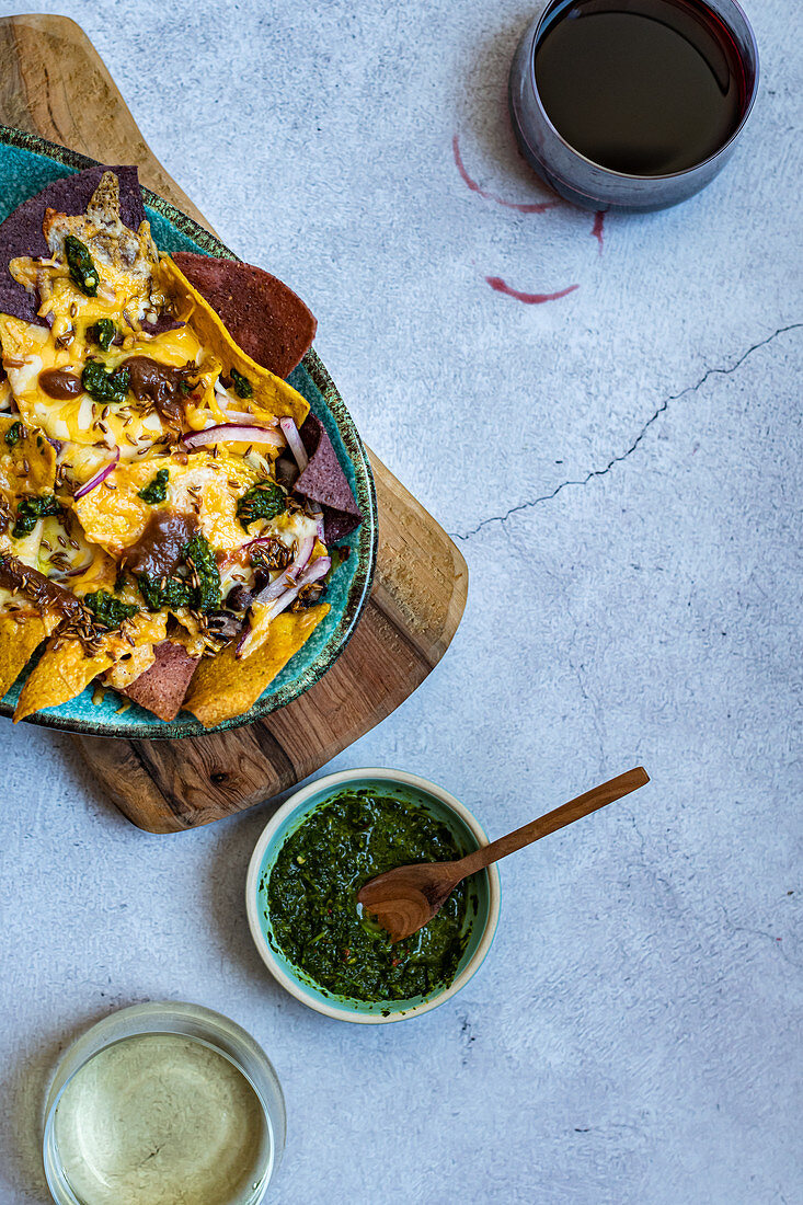 Nachos with coriander chutney, cheese, black beans and tempered spices