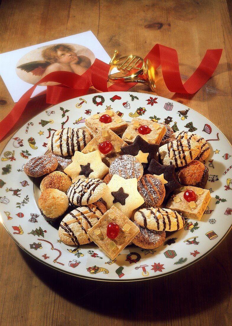 Various Christmas biscuits on colourful Christmas plate