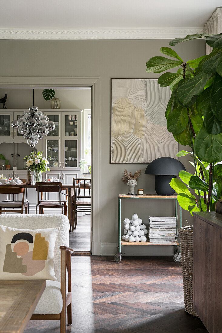 Living room in natural colors, view into the dining room