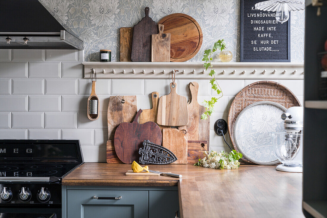 Kitchen worktop over corner with collection of chopping boards