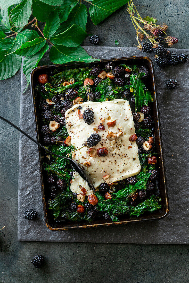 Baked feta with blackberries and kale