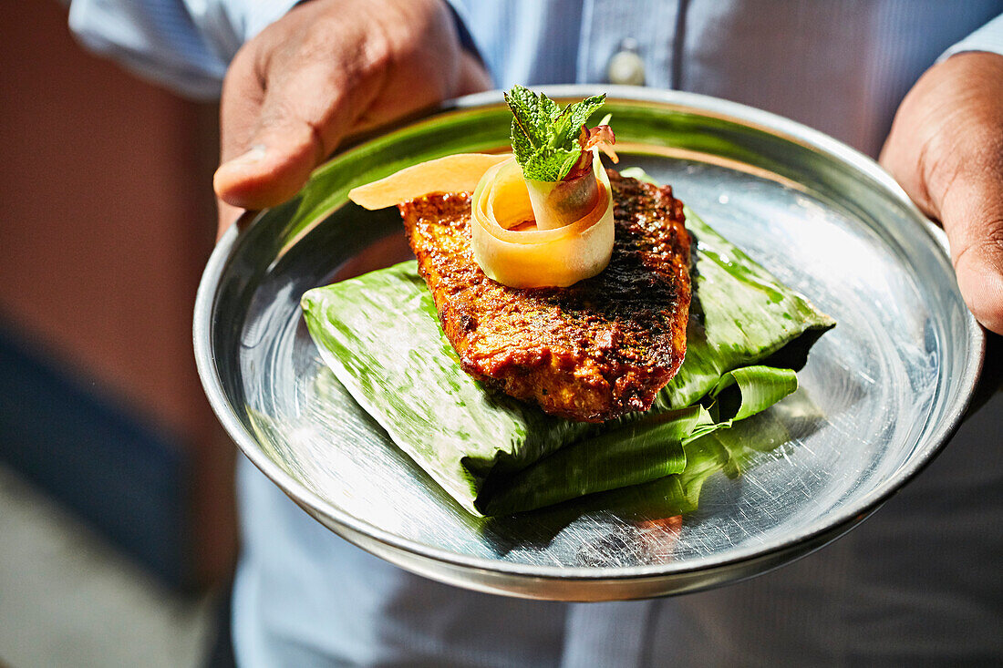 Curry fish served on a banana leaf