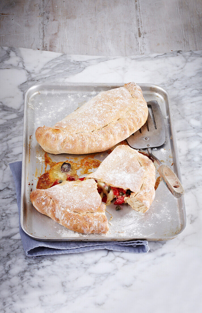 Calzone stuffed with peppers, olives, and capers