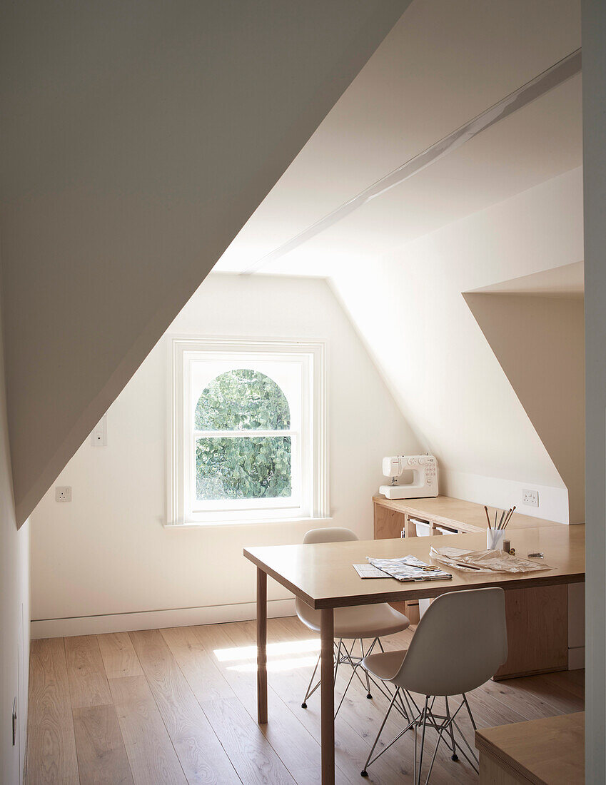 A bright study with a desk in the attic
