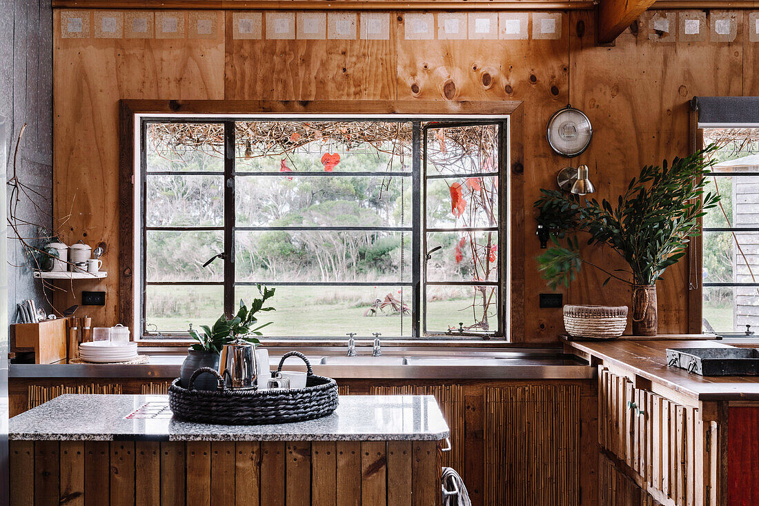 Rustic kitchen made of recycled wood, kitchen island with marble top