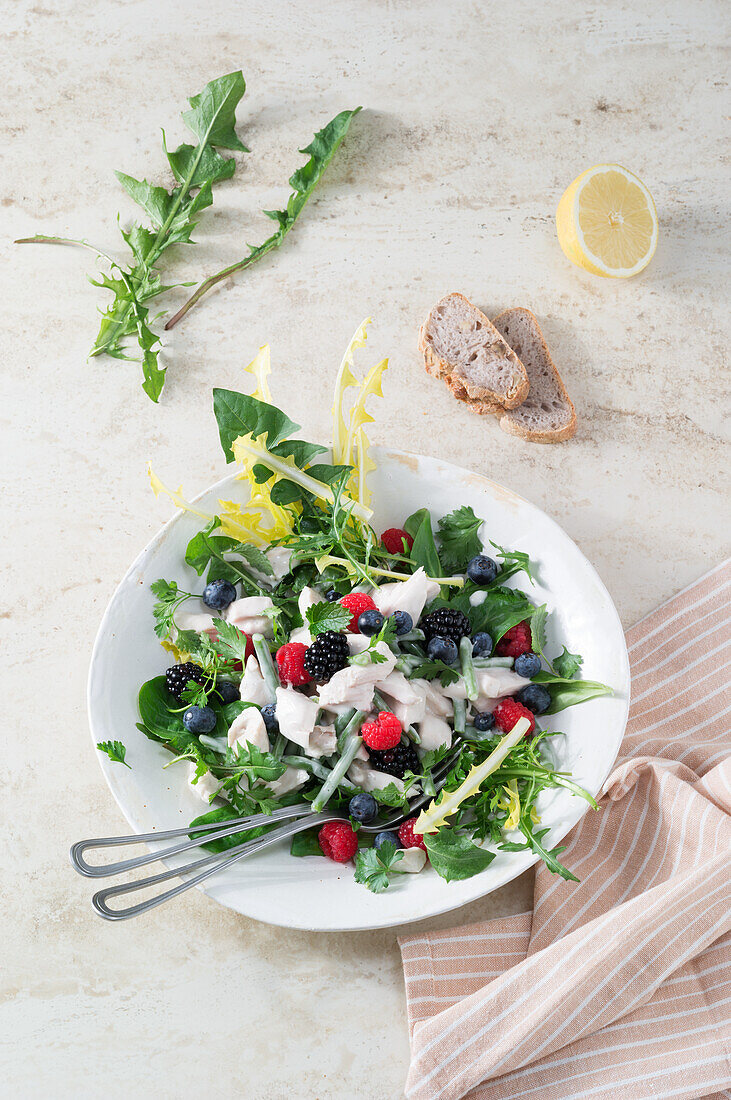 Chicken salad with dandelion, rocket, and berries