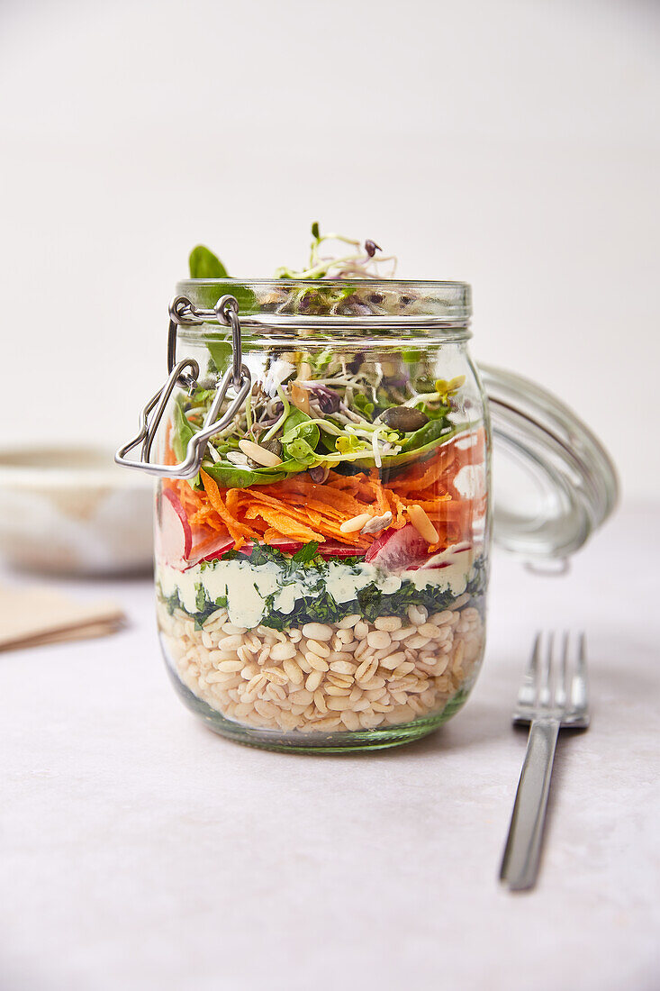 Layered spelt lunch salad with silken tofu in a jar
