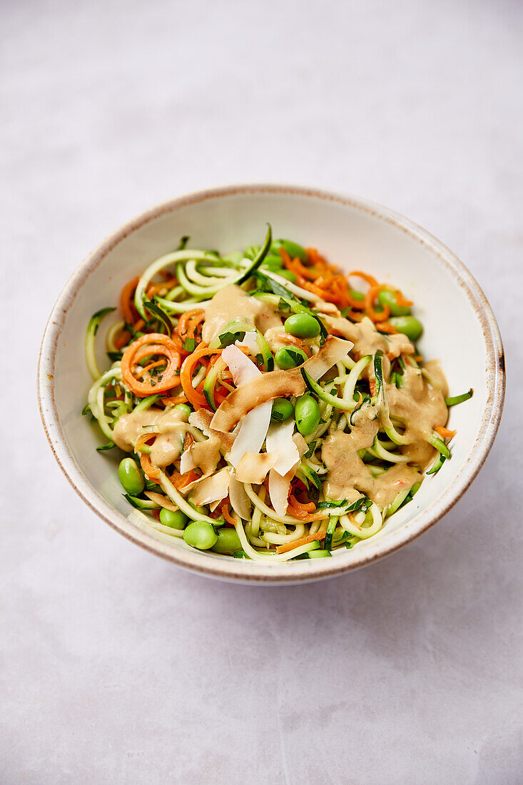 Vegetable zoodles with edamame and peanut coconut sauce